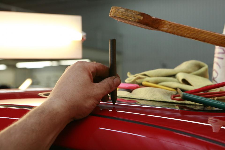 Hands-on repair work on a car in the shop