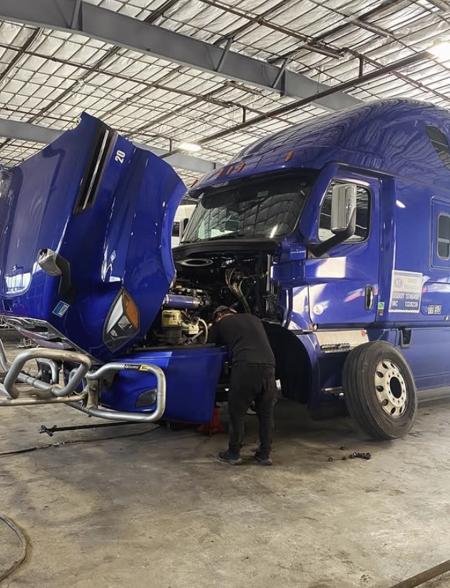 Technician working on an open diesel engine at Best Way Truck & Trailer Repair