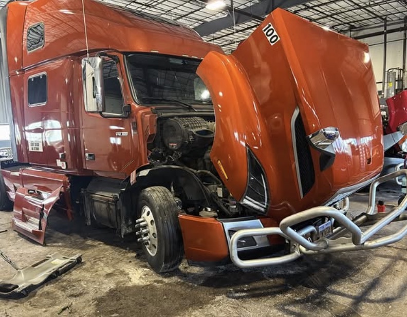 Volvo VNL with the hood open for engine work
