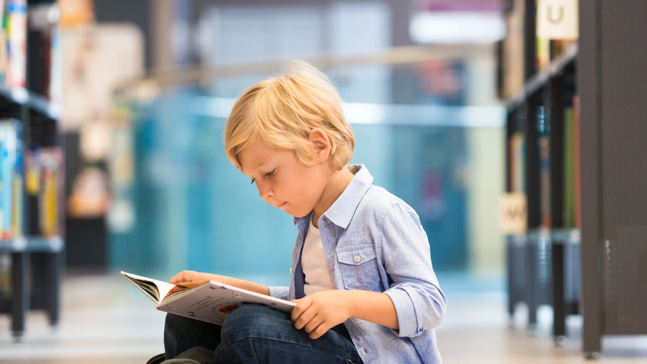 A young boy absorbed in a book