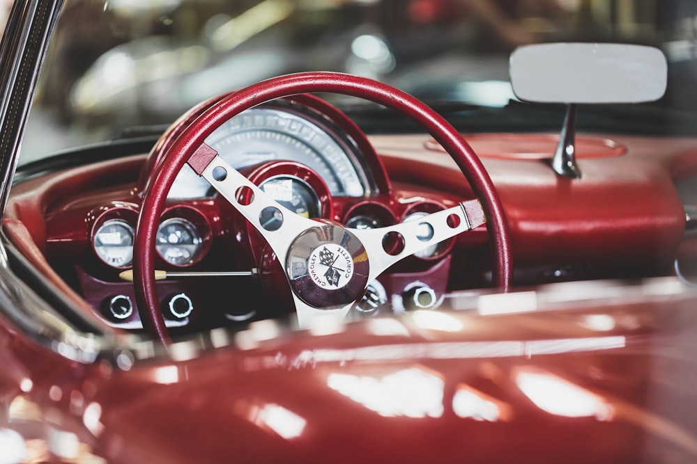 Classic car interior with red steering wheel