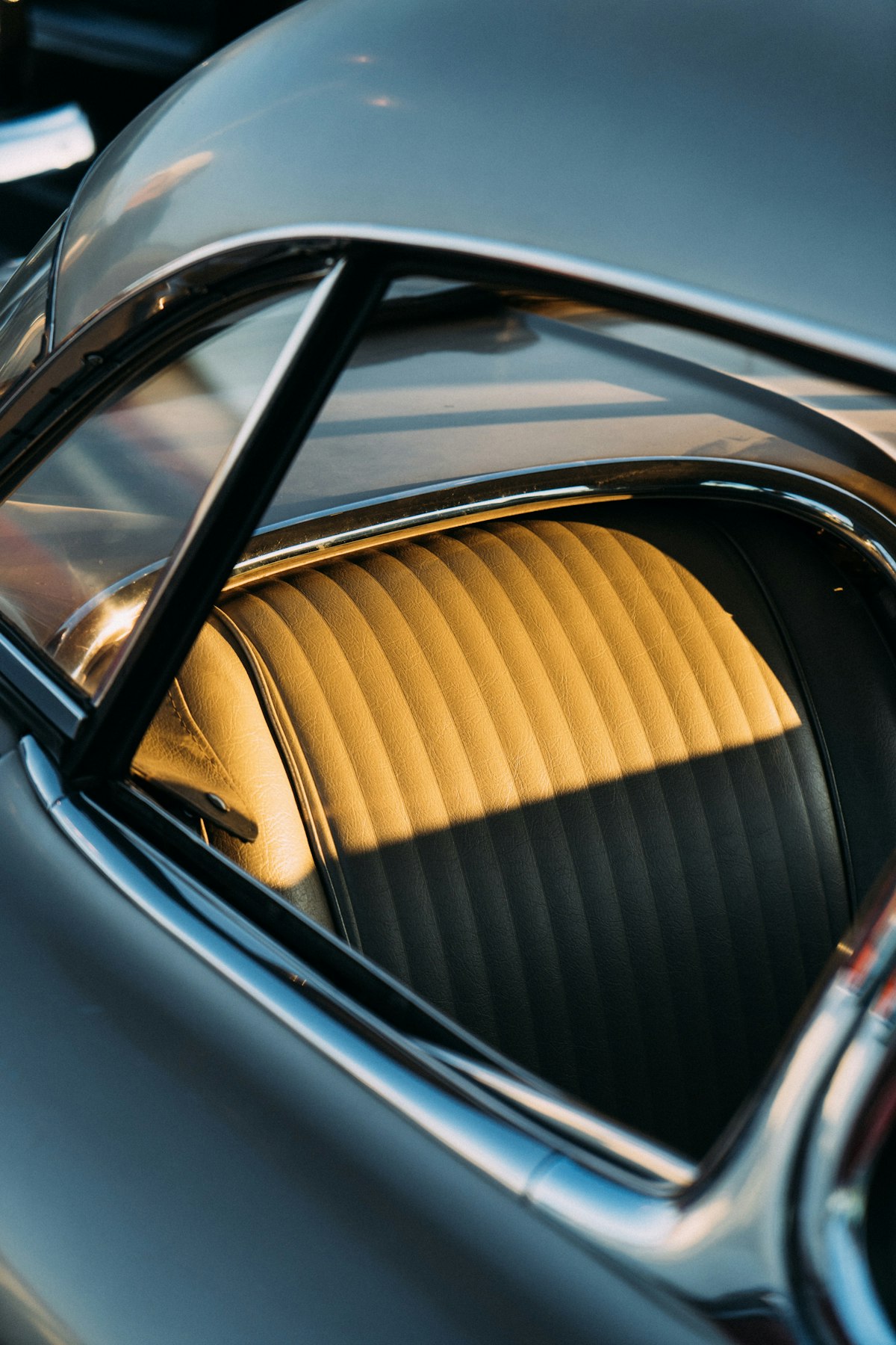 Pleated classic car seat seen through a rear window