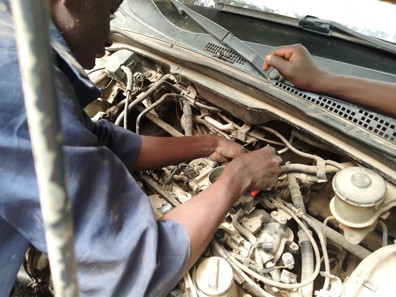 Mechanic working on a car engine