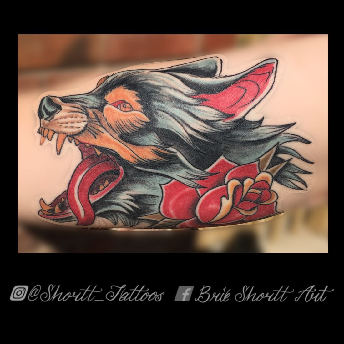 Traditional wolf and rose tattoo