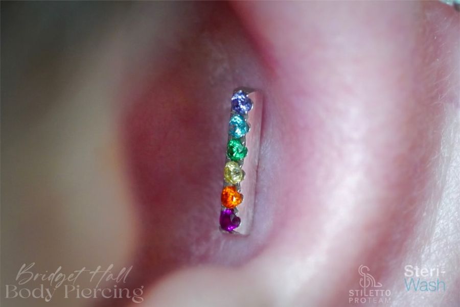 Rainbow gem ear bar piercing