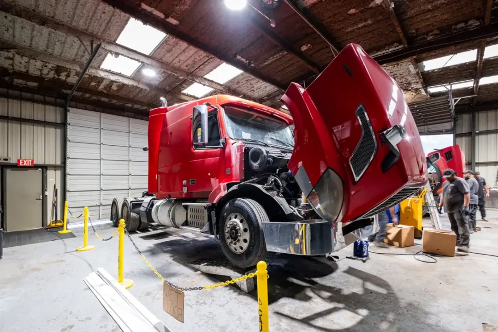 Tractor in the Fortuna service bay with the hood open