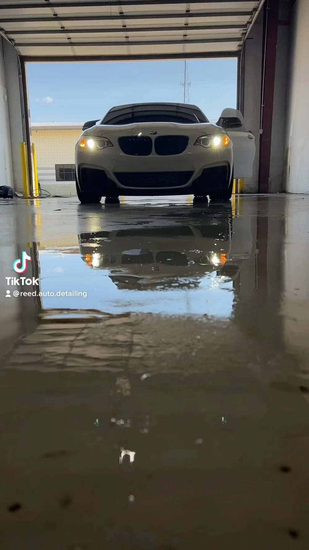 Freshly detailed BMW reflected in the shop floor