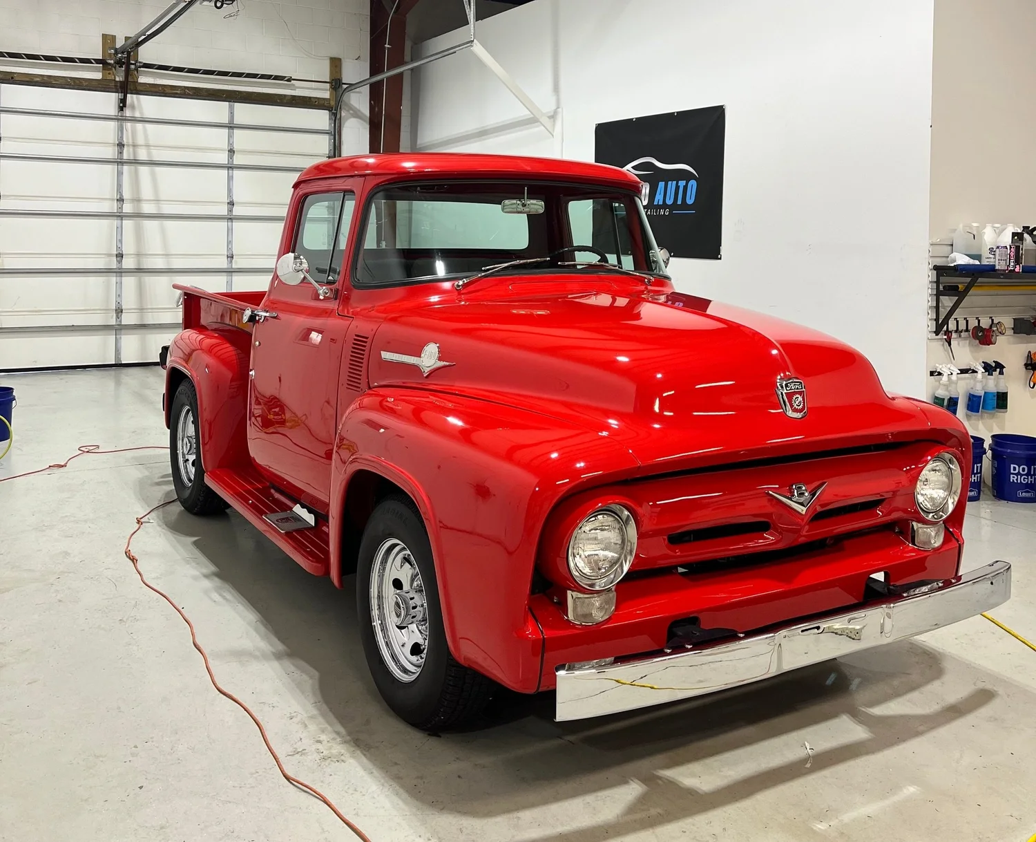 Classic red Ford F100 detailed to a mirror shine in the Reed Auto shop