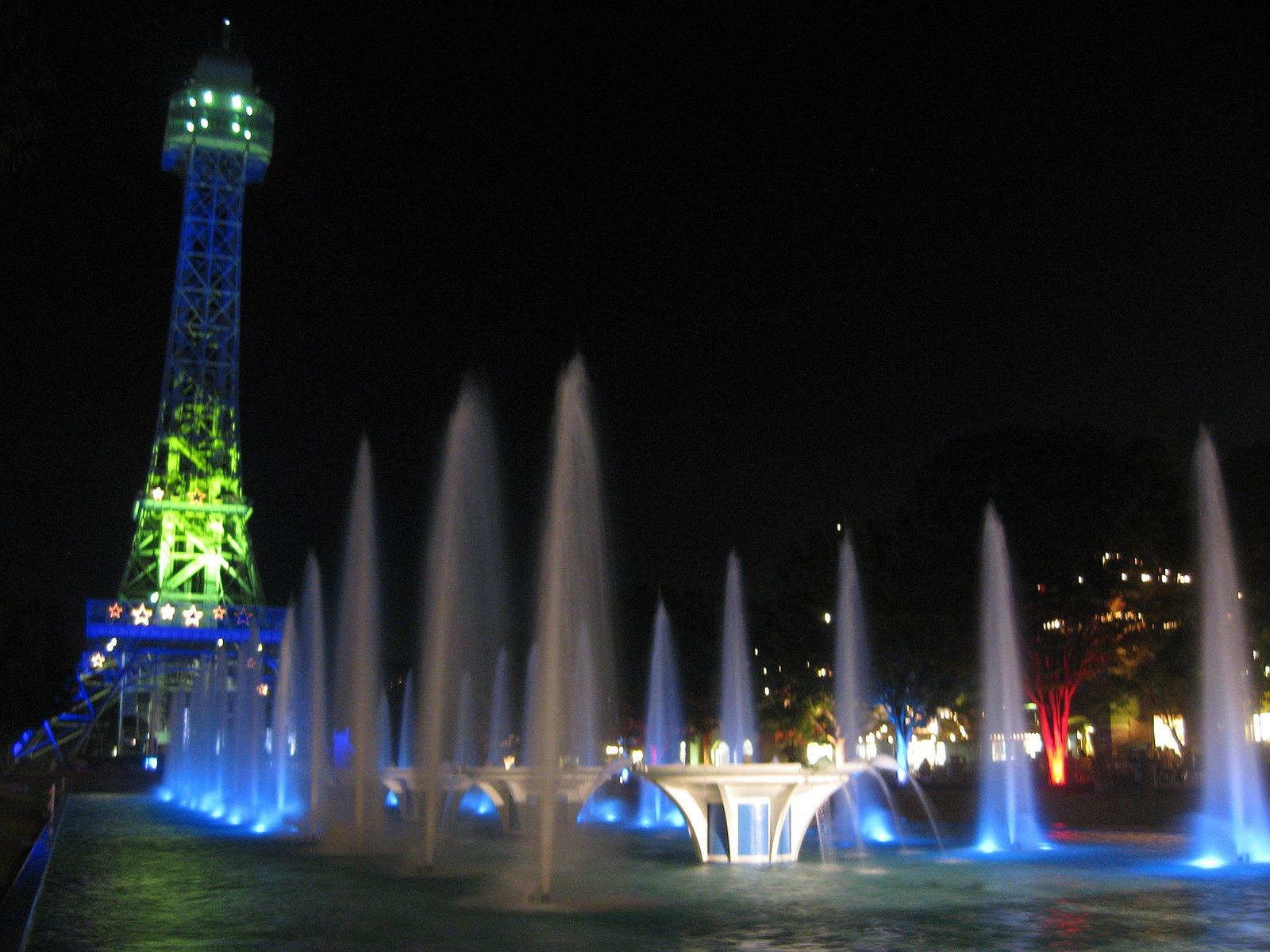 Kings Island's Eiffel Tower and fountains lit at night