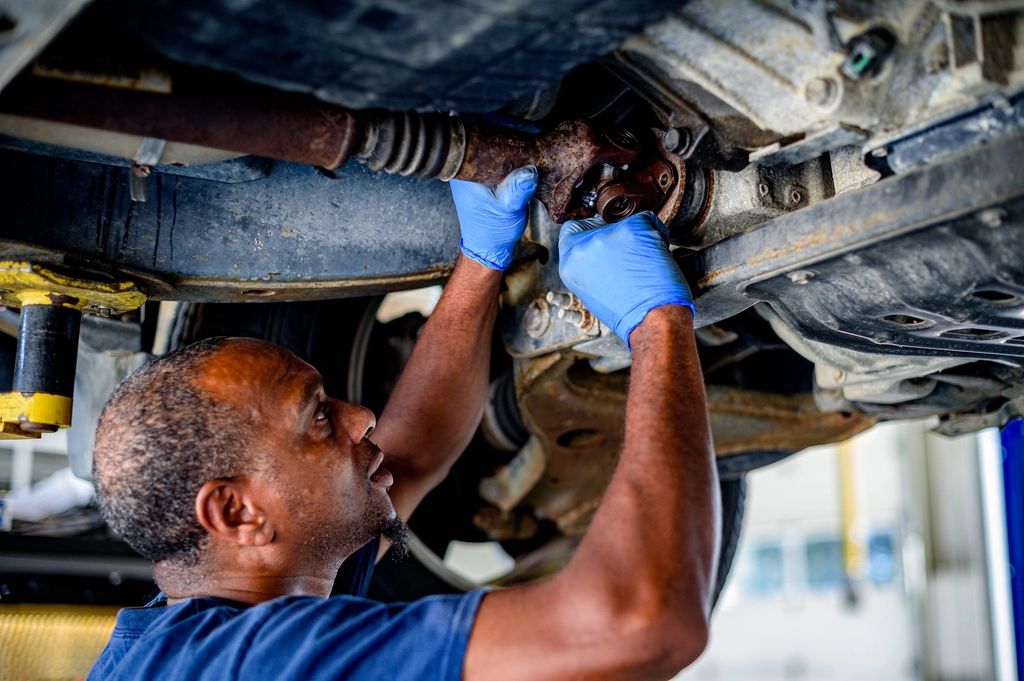 Technician servicing a vehicle